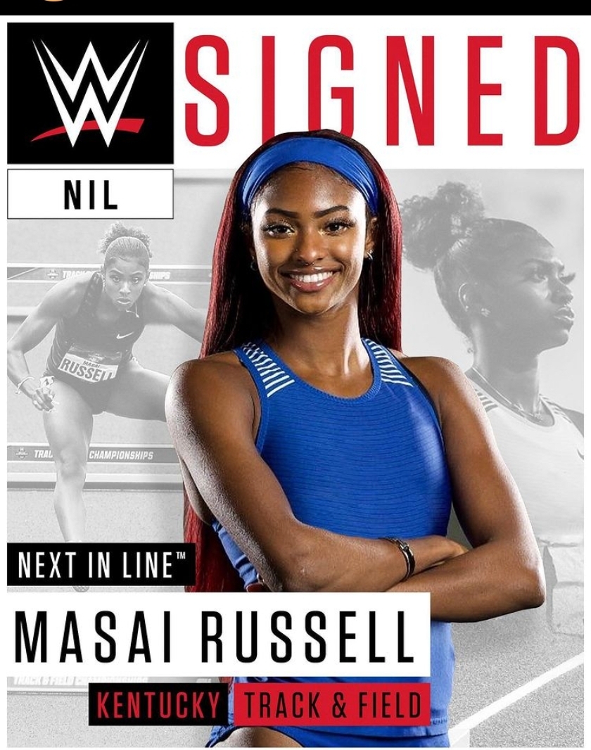 Smiling female track athlete in blue uniform