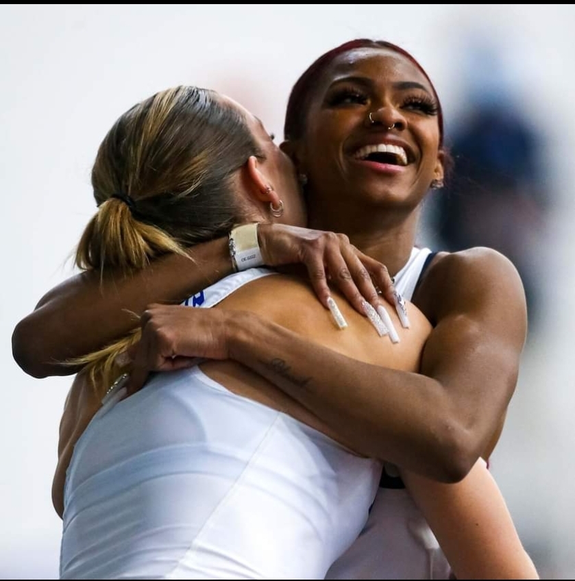 Two athletes embracing in joyful celebration